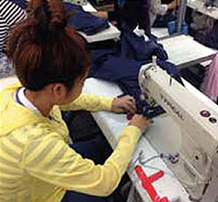 Machinist sewing denim on an industrial sewing machine