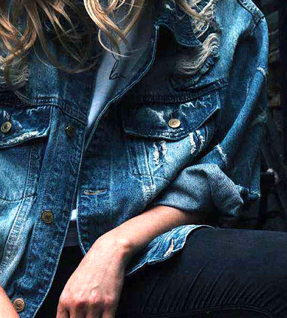 Distressed denim jacket worn with black jeans